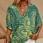 Top holgado de mujer con cuello en V y estampado, con mangas murciélago, ideal para vacaciones.