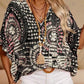 Top holgado de mujer con cuello en V y estampado, con mangas murciélago, ideal para vacaciones.